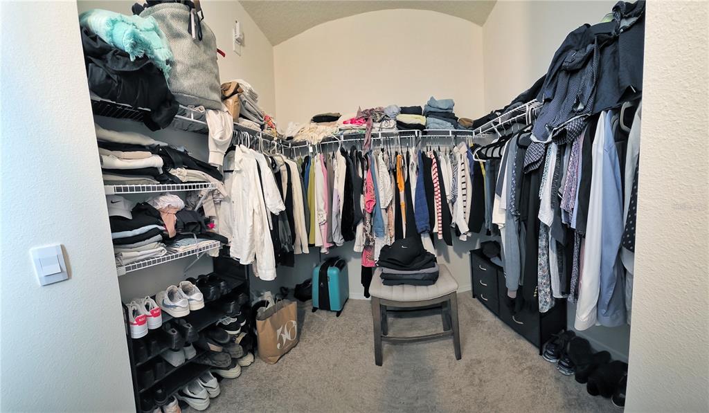 1724 Buckeye Road Davenport, FL 33837 - Photo 49 of 53 a view of walk in closet with clothes and shoes