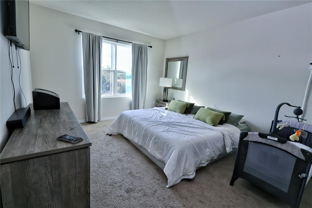 1724 Buckeye Road Davenport, FL 33837 - Photo 50 of 53 a bedroom with a bed and a window