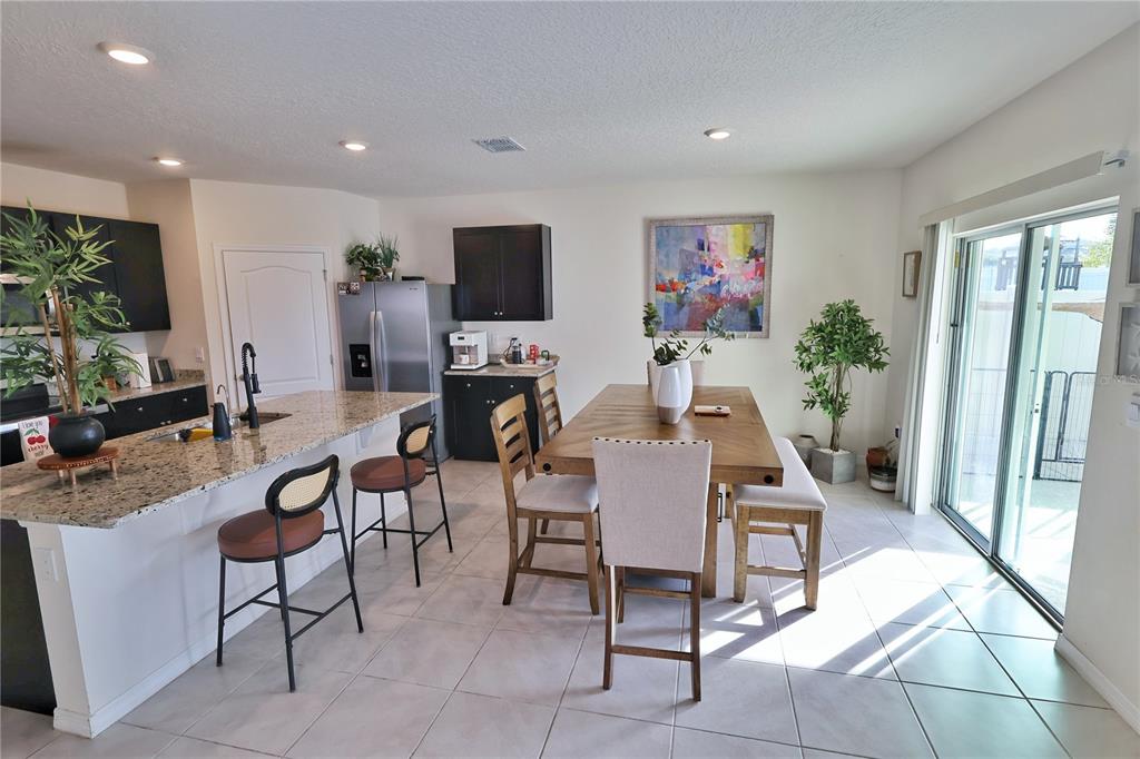 1724 Buckeye Road Davenport, FL 33837 - Photo 6 of 53 a living room with furniture a flat screen tv and a floor to ceiling window