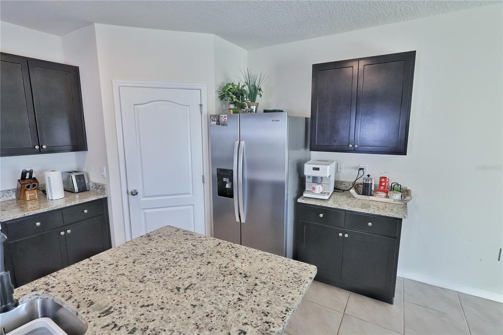 1724 Buckeye Road Davenport, FL 33837 - Photo 9 of 53 a kitchen with a refrigerator and a sink