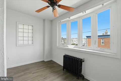 a view of a hallway with wooden floor and closet