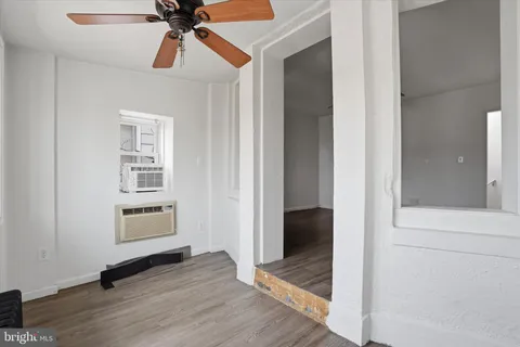wooden floor in an empty room with a window