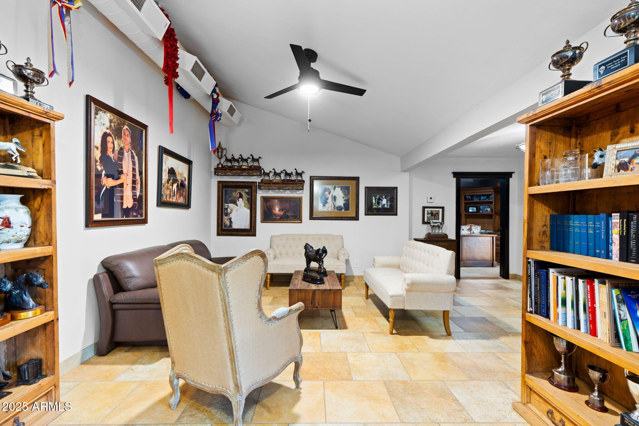 6835 East Peak View Road Scottsdale, AZ 85266 - Photo 37 of 107 a living room with fireplace furniture and a book shelf