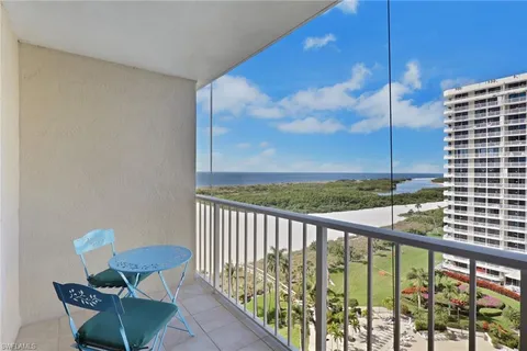 a view of a chairs and table in the balcony