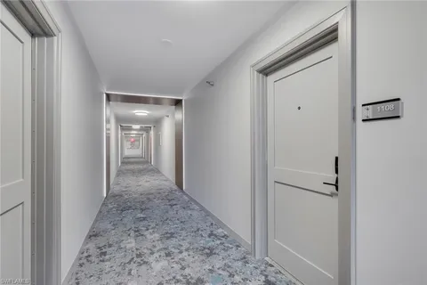 a view of a hallway with a hallway to a bedroom