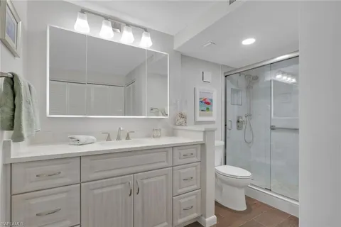 a bathroom with a toilet sink and shower