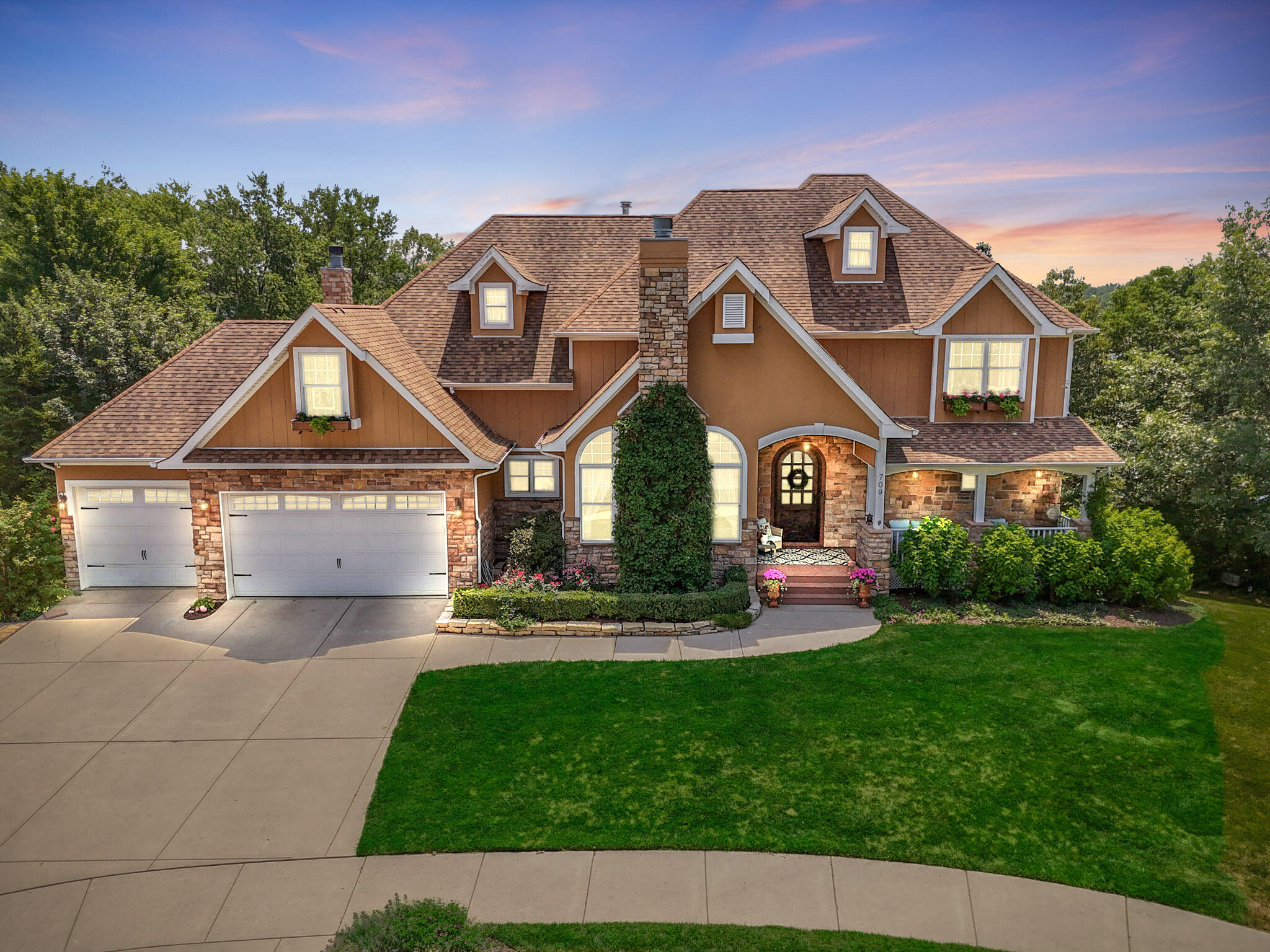 a front view of a house with a garden
