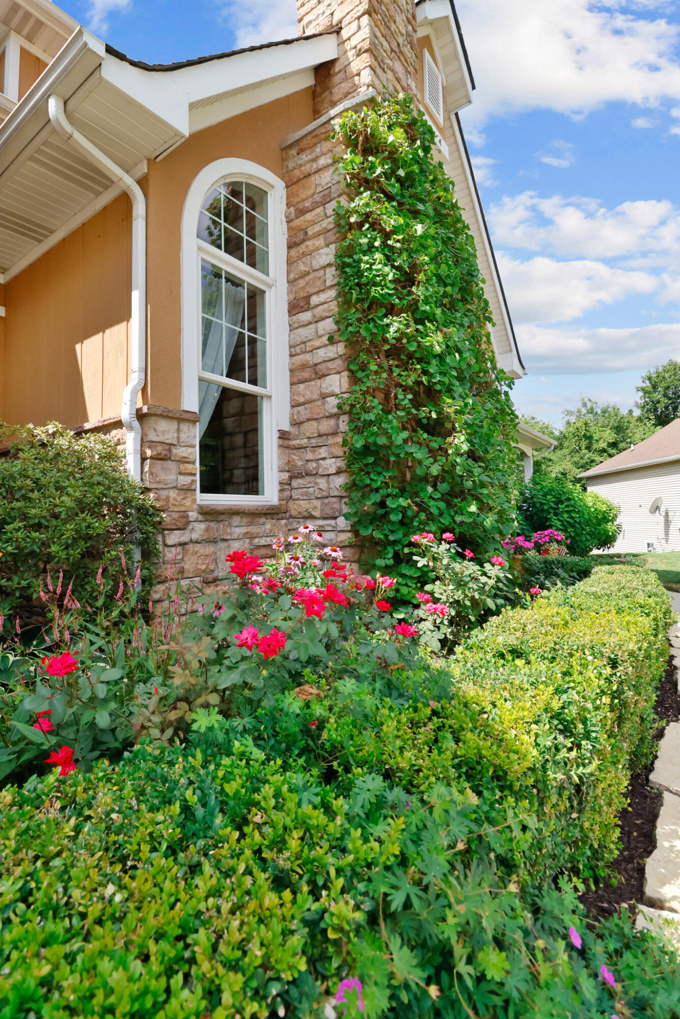 709 Pennock Circle Crown Point, IN 46307 - Photo 3 of 67 a view of a flower garden in front of a house