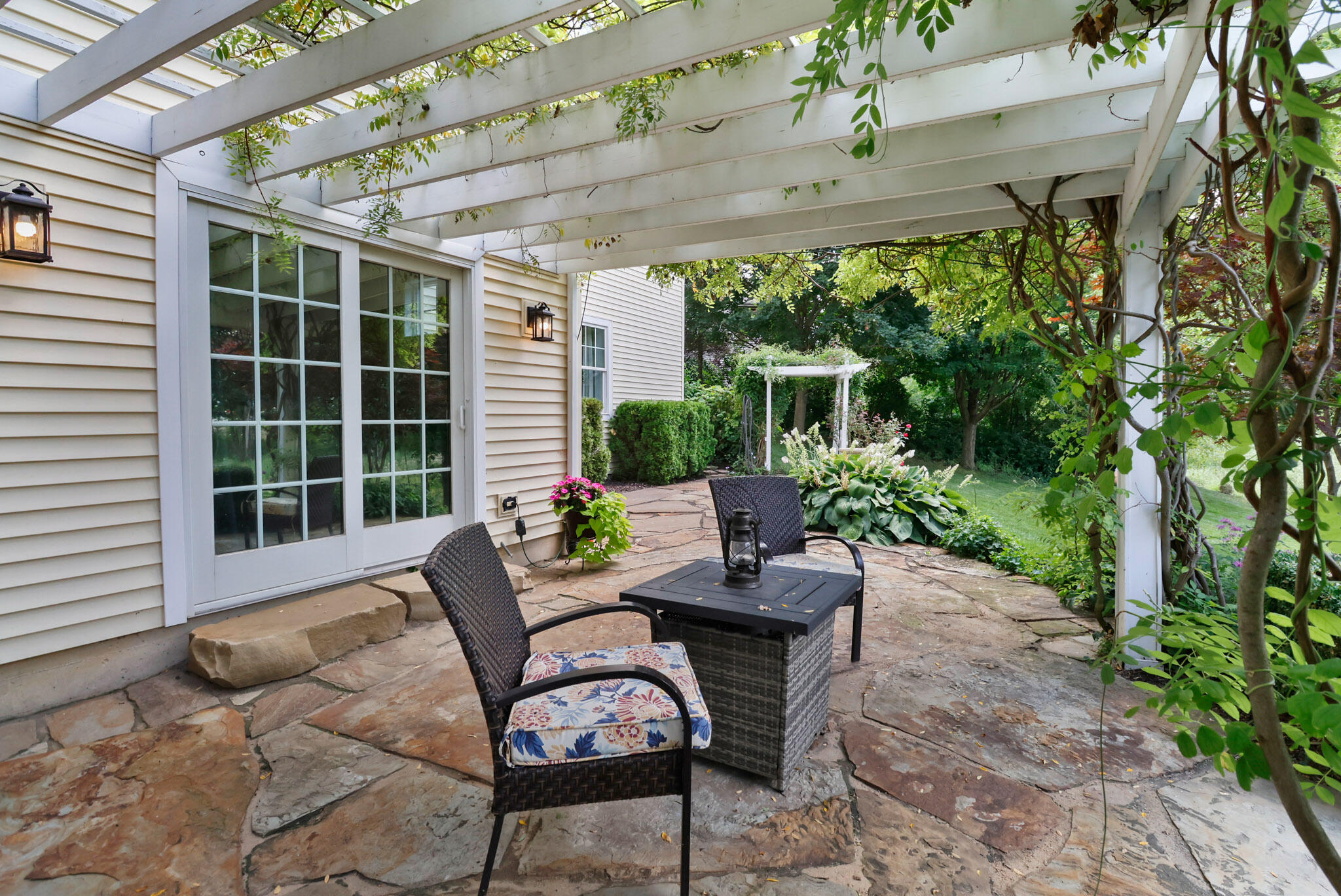 709 Pennock Circle Crown Point, IN 46307 - Photo 57 of 67 a view of a patio with table and chairs potted plants with floor to ceiling window and potted plants