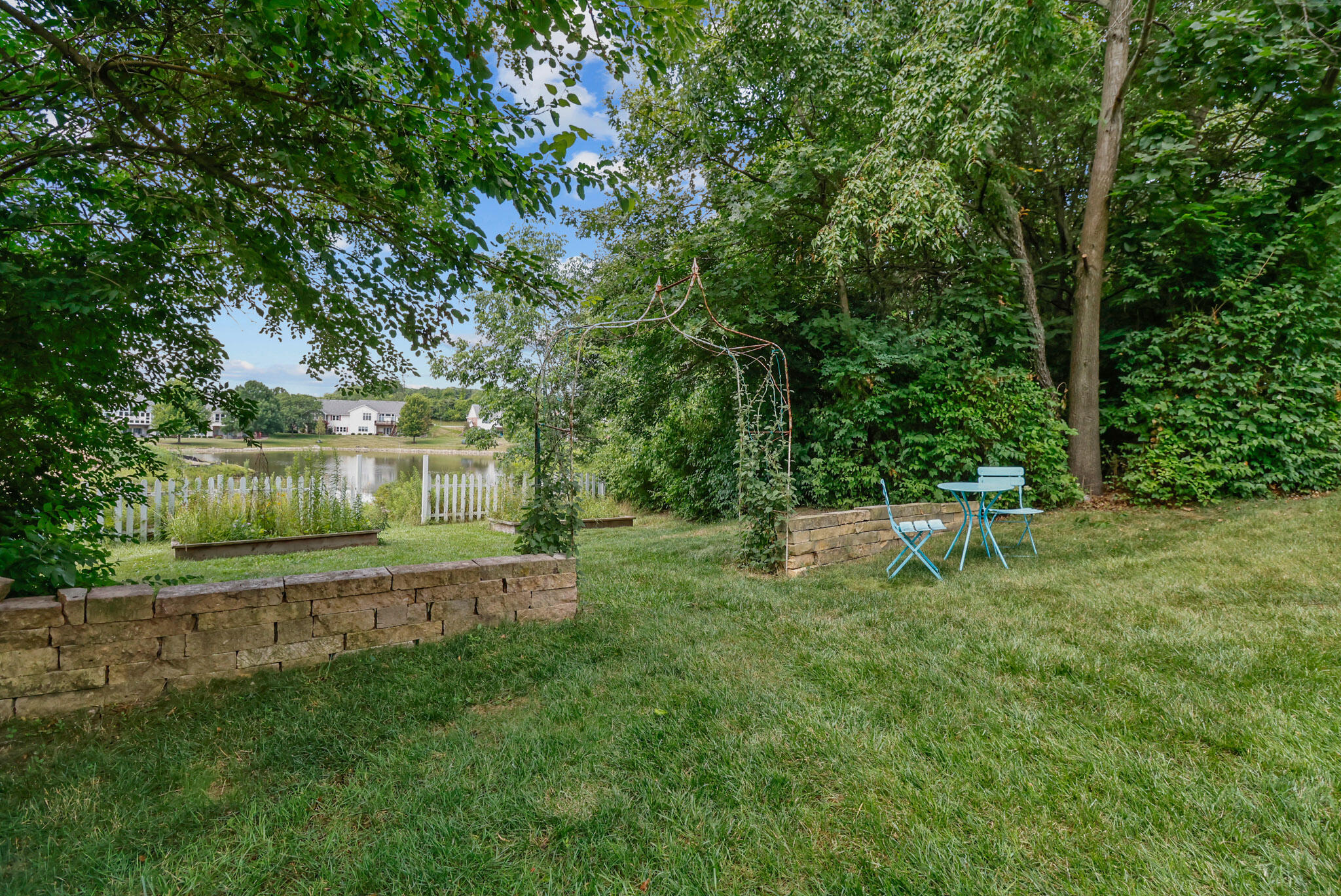 709 Pennock Circle Crown Point, IN 46307 - Photo 62 of 67 a view of a backyard with a garden and fire pit