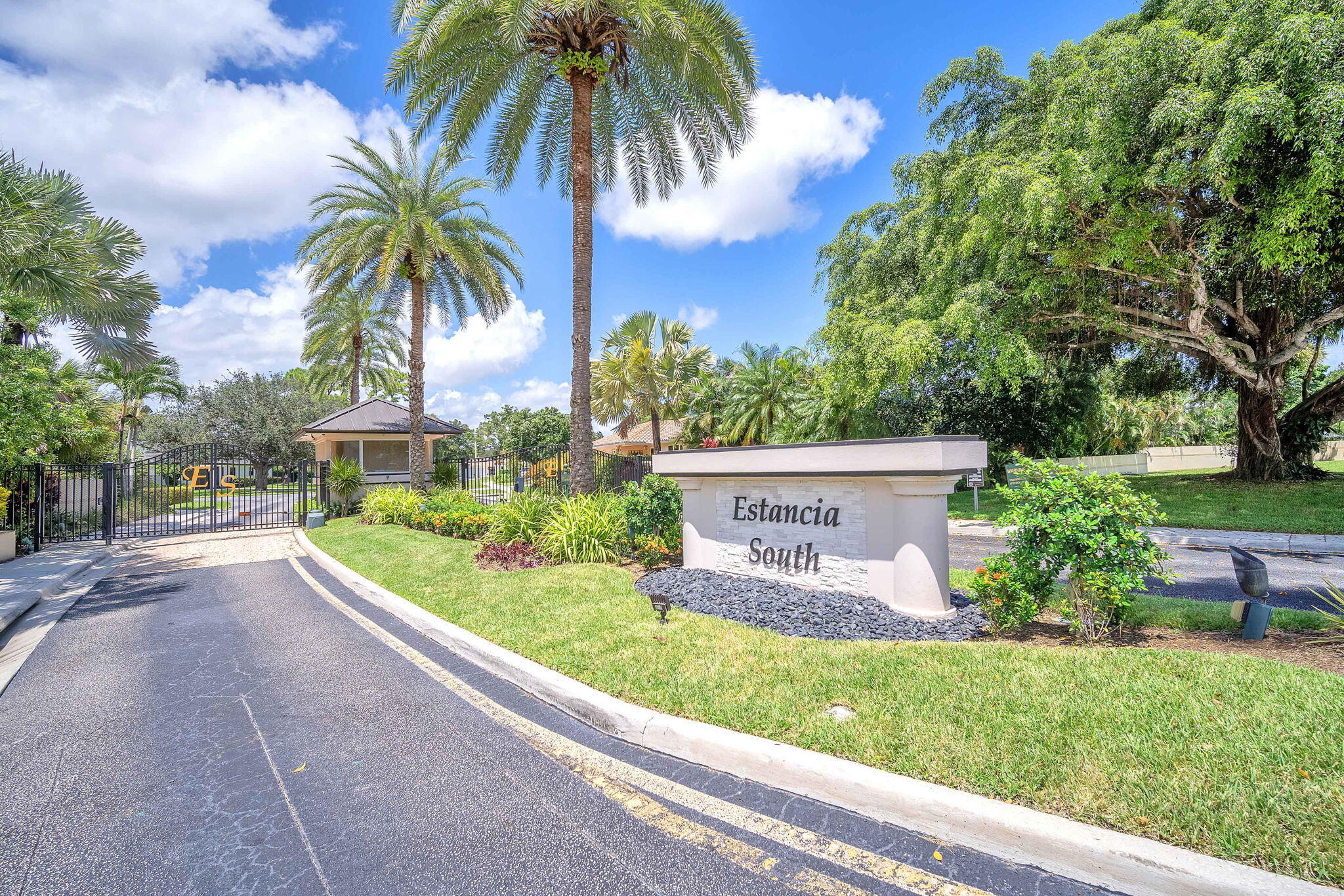 6794 Giralda Circle Boca Raton, FL 33433 - Photo 2 of 49 a front view of a house with fountain and potted plants