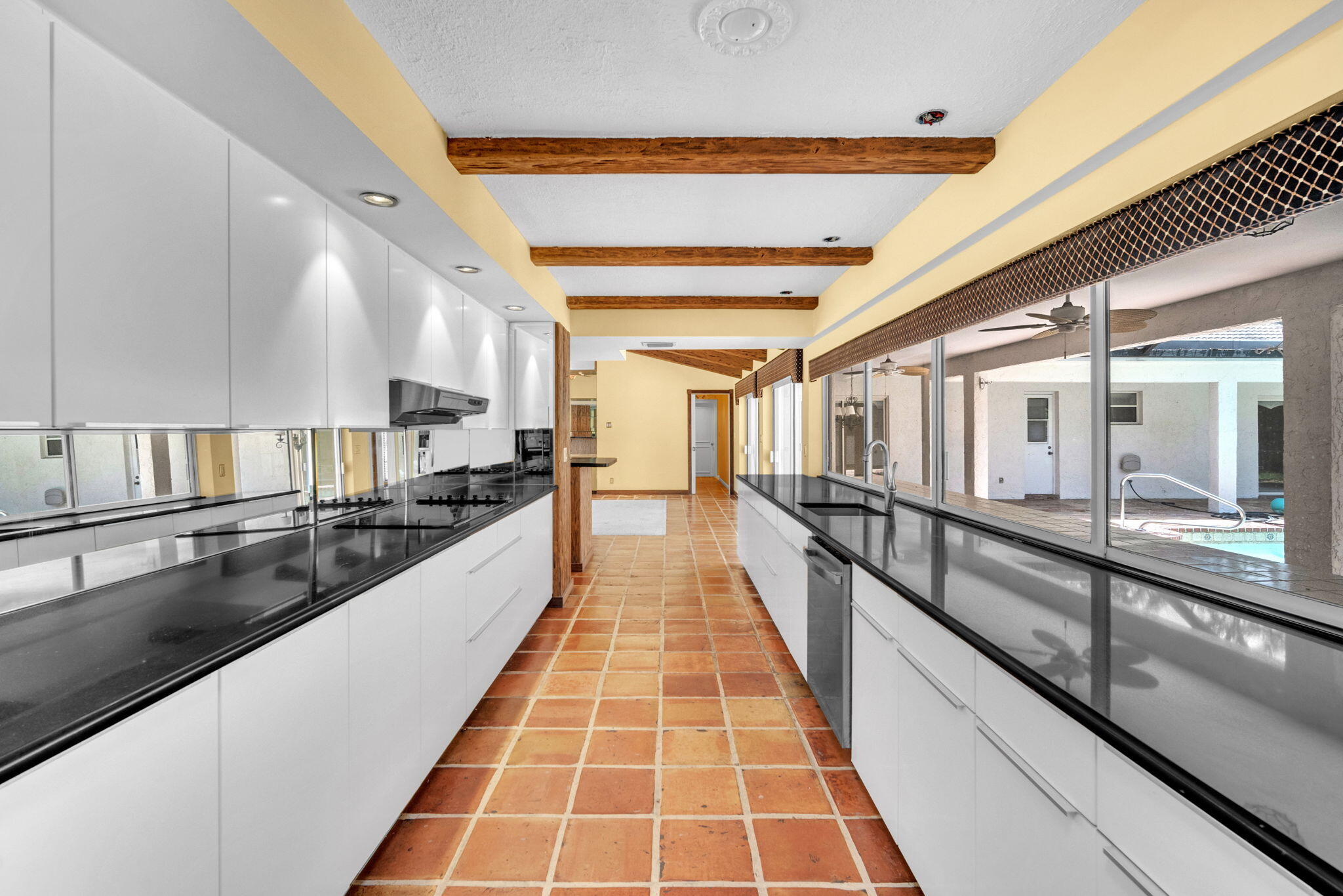 6794 Giralda Circle Boca Raton, FL 33433 - Photo 34 of 49 a large white kitchen with kitchen island a counter space a sink and stainless steel appliances