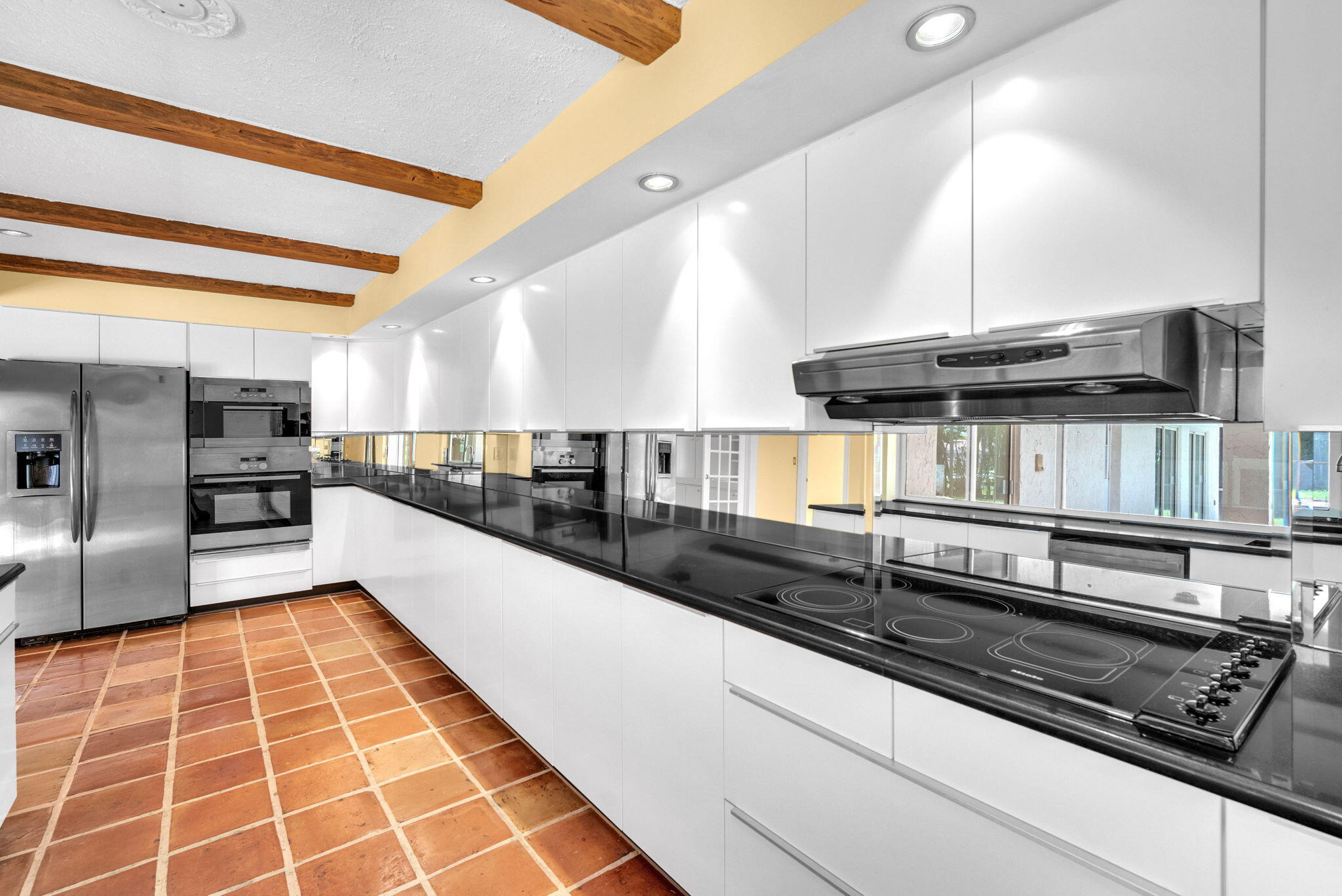 6794 Giralda Circle Boca Raton, FL 33433 - Photo 35 of 49 a large kitchen with stainless steel appliances kitchen island granite countertop a sink and cabinets