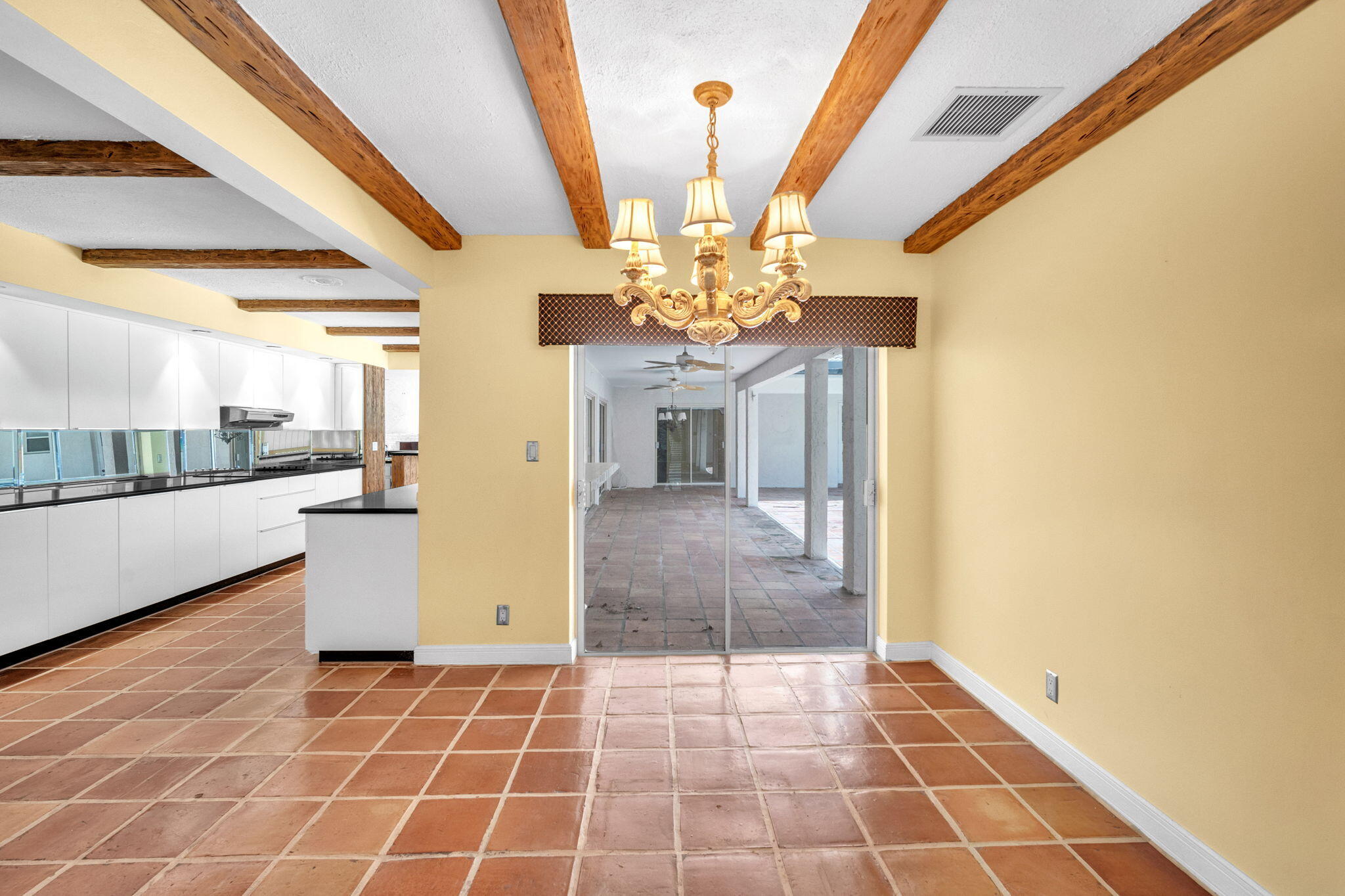 6794 Giralda Circle Boca Raton, FL 33433 - Photo 37 of 49 a hallway with a dining table chair and a kitchen view