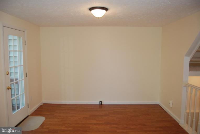 1488 Autumn Ridge Circle Reston, VA 20194 - Photo 6 of 30 a view of an empty room with wooden floor and a window