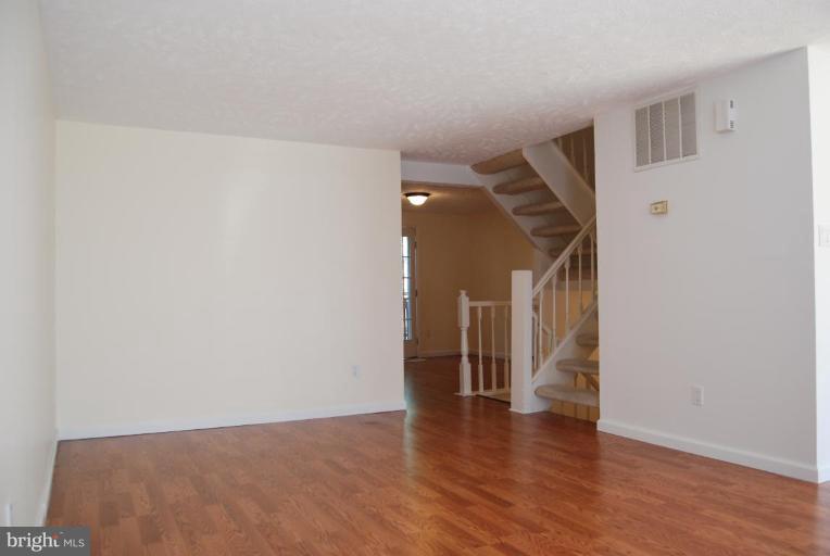 1488 Autumn Ridge Circle Reston, VA 20194 - Photo 8 of 30 a view of a hallway with wooden floor and entryway