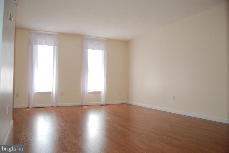 1488 Autumn Ridge Circle Reston, VA 20194 - Photo 9 of 30 wooden floor in an empty room with a window