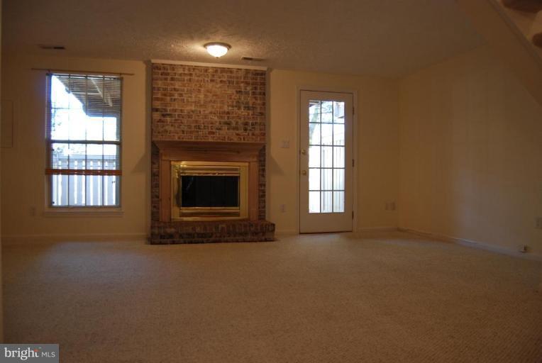 1488 Autumn Ridge Circle Reston, VA 20194 - Photo 10 of 30 an empty room with windows and fireplace