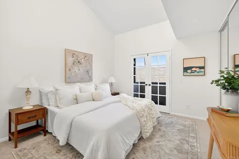 a bedroom with a bed and a potted plant