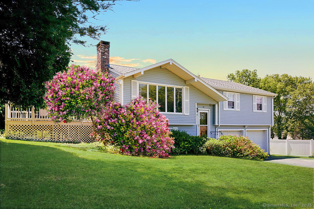 a front view of a house with a garden