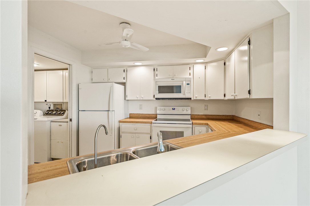 1850 Bay Road, Unit 3F Vero Beach, FL 32963 - Photo 13 of 34 a kitchen with stainless steel appliances a refrigerator sink and microwave