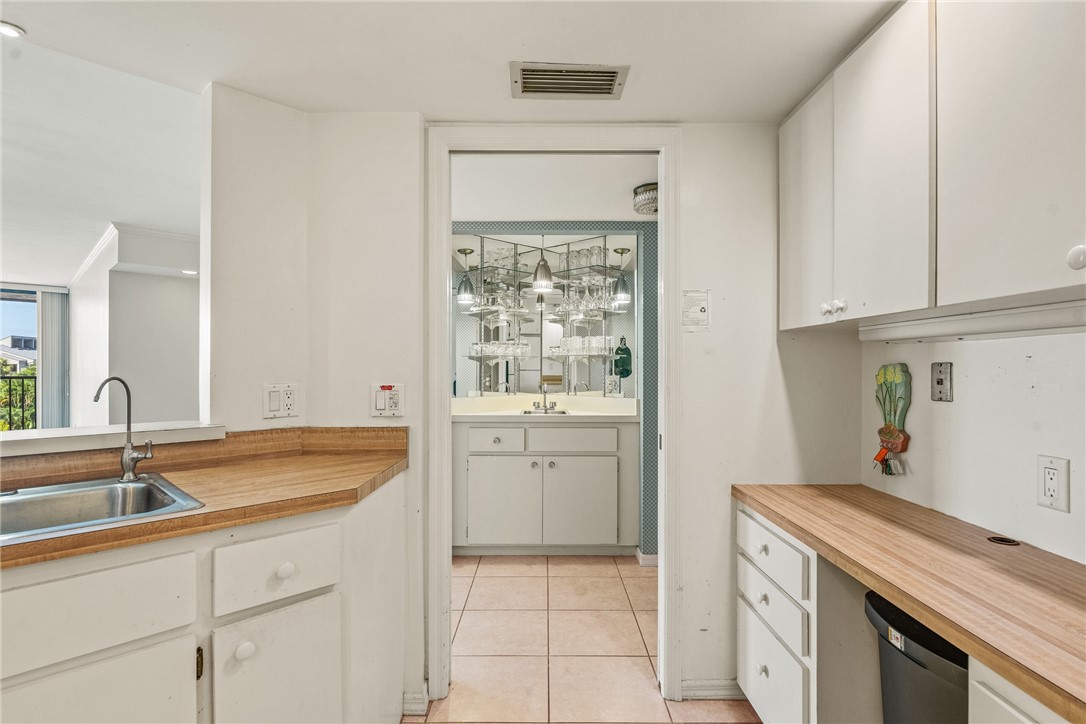 1850 Bay Road, Unit 3F Vero Beach, FL 32963 - Photo 18 of 34 a kitchen with a sink and cabinets