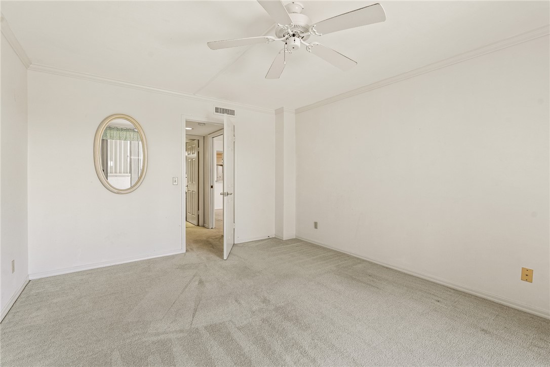 1850 Bay Road, Unit 3F Vero Beach, FL 32963 - Photo 25 of 34 an empty room with a mirror and a fan