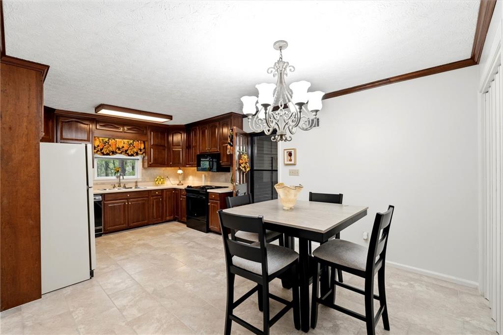 3121 Bonds Lake Road Northwest Conyers, GA 30012 - Photo 12 of 36 a view of a dining room with furniture and chandelier