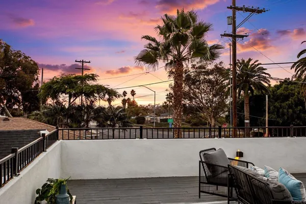 a terrace with outdoor seating and city view