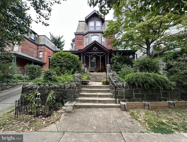a view of house with yard and green space