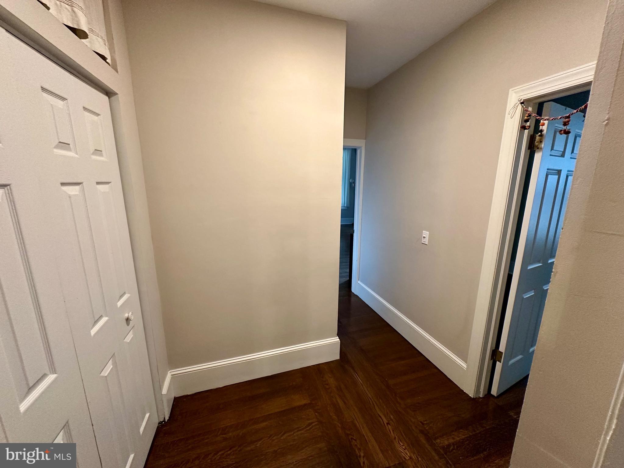 4805 Springfield Avenue Philadelphia, PA 19143 - Photo 11 of 22 an empty room with wooden floor and a hallway