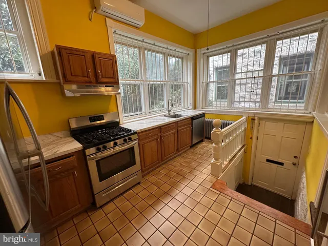 a kitchen with a sink and wooden cabinets