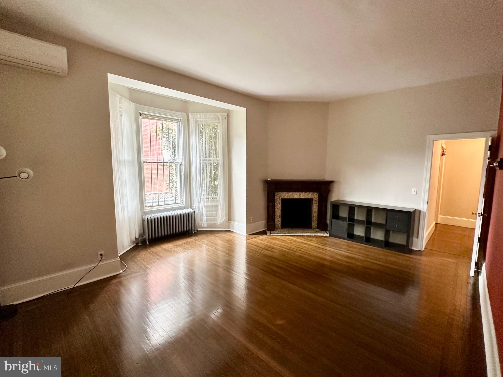 4805 Springfield Avenue Philadelphia, PA 19143 - Photo 7 of 22 a view of an empty room with wooden floor and a window