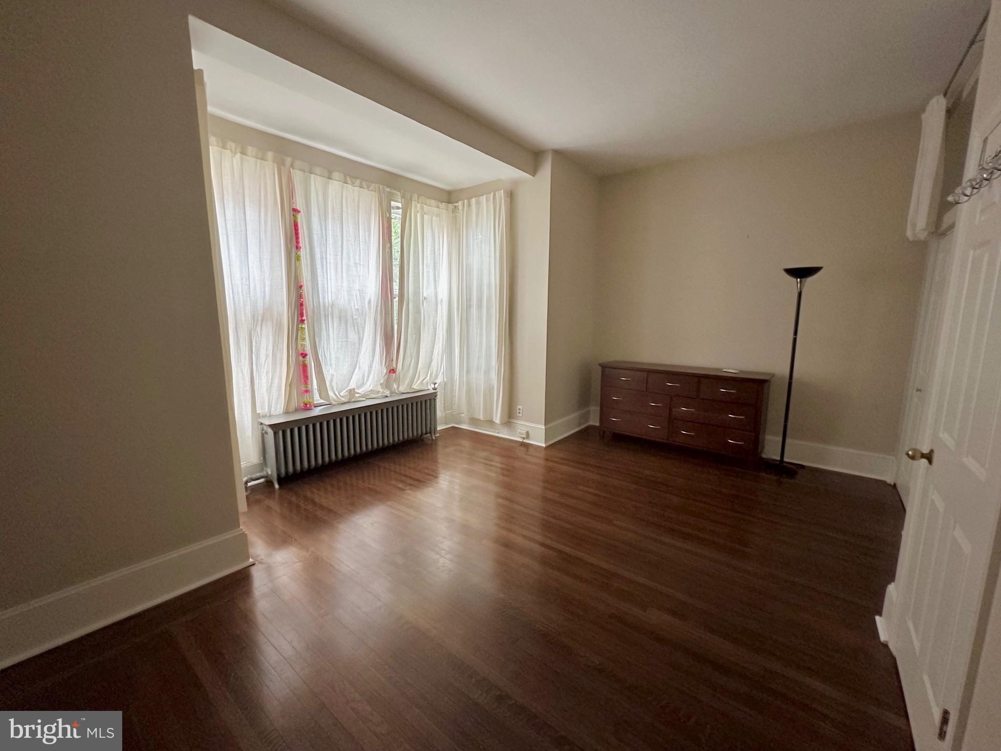 4805 Springfield Avenue Philadelphia, PA 19143 - Photo 9 of 22 a view of an empty room with a window and wooden floor