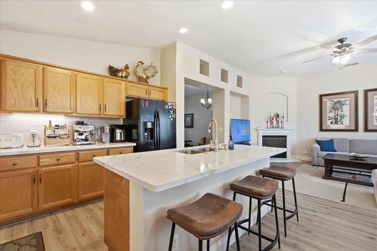 7821 Shell Beach Drive Antelope, CA 95843 - Photo 15 of 40 a large kitchen with cabinets chairs and refrigerator