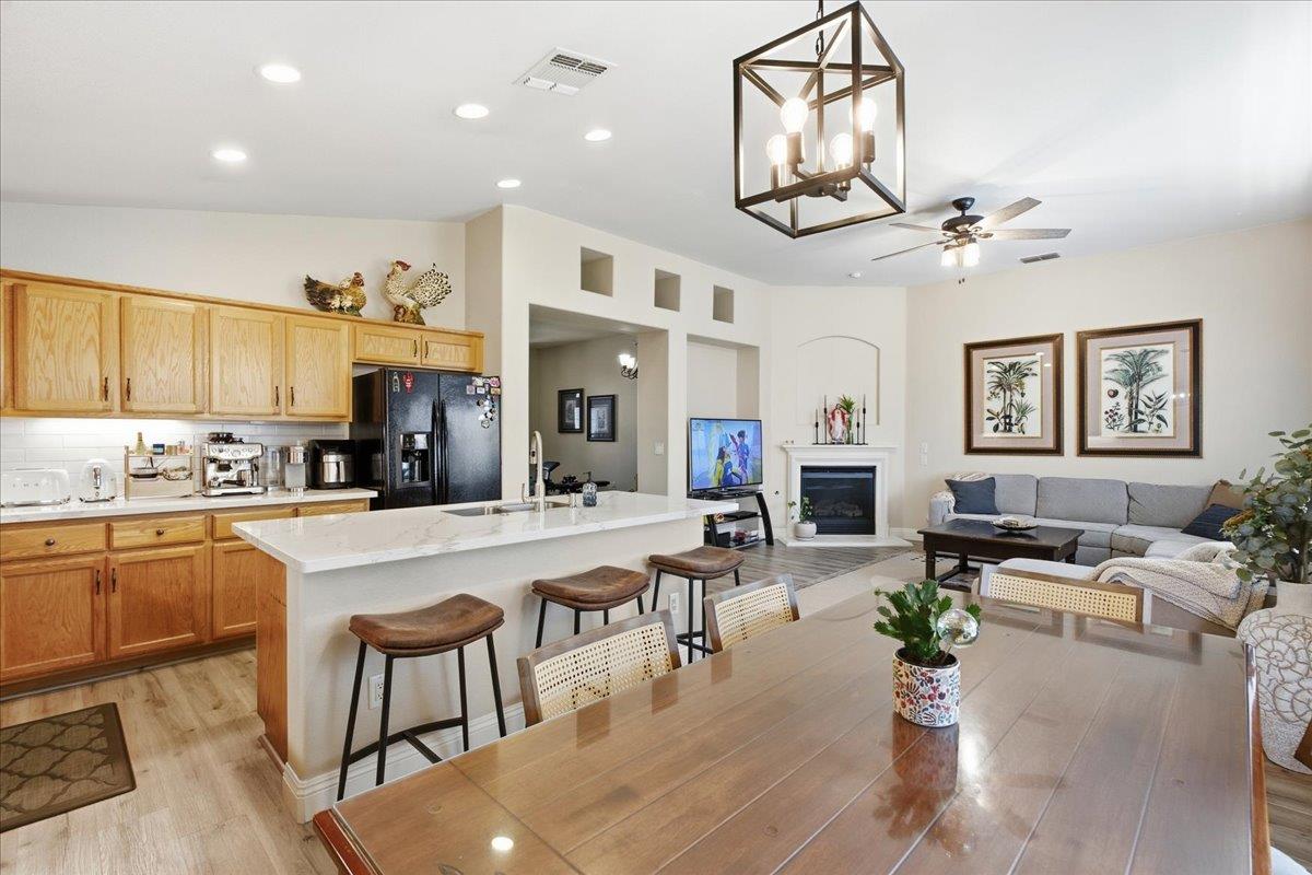 7821 Shell Beach Drive Antelope, CA 95843 - Photo 19 of 40 a large kitchen with a table chairs refrigerator and cabinets
