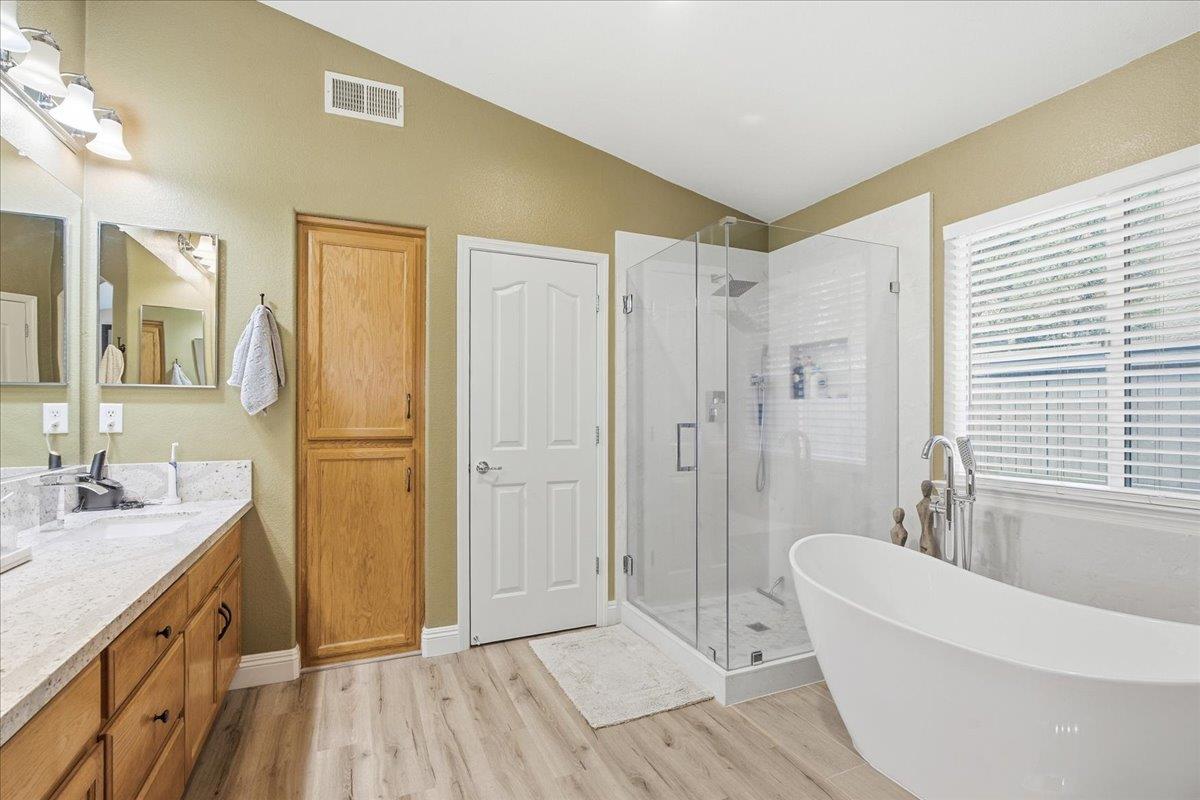 7821 Shell Beach Drive Antelope, CA 95843 - Photo 25 of 40 a spacious bathroom with a double vanity sink a mirror and a bathtub