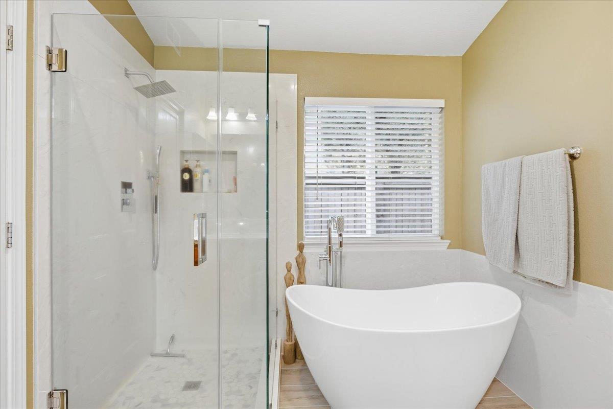 7821 Shell Beach Drive Antelope, CA 95843 - Photo 27 of 40 a bathroom with a white bath tub sitting next to a window