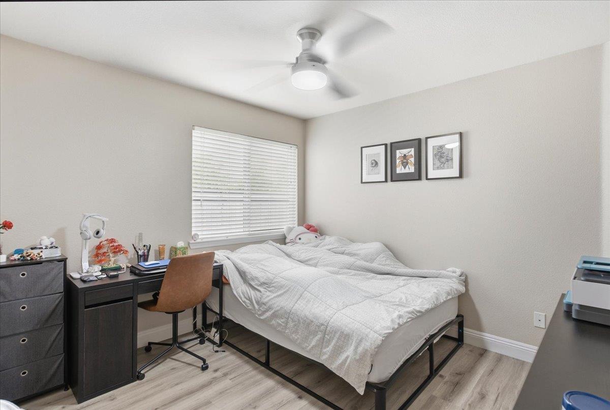 7821 Shell Beach Drive Antelope, CA 95843 - Photo 30 of 40 a bedroom with a bed and a chandelier