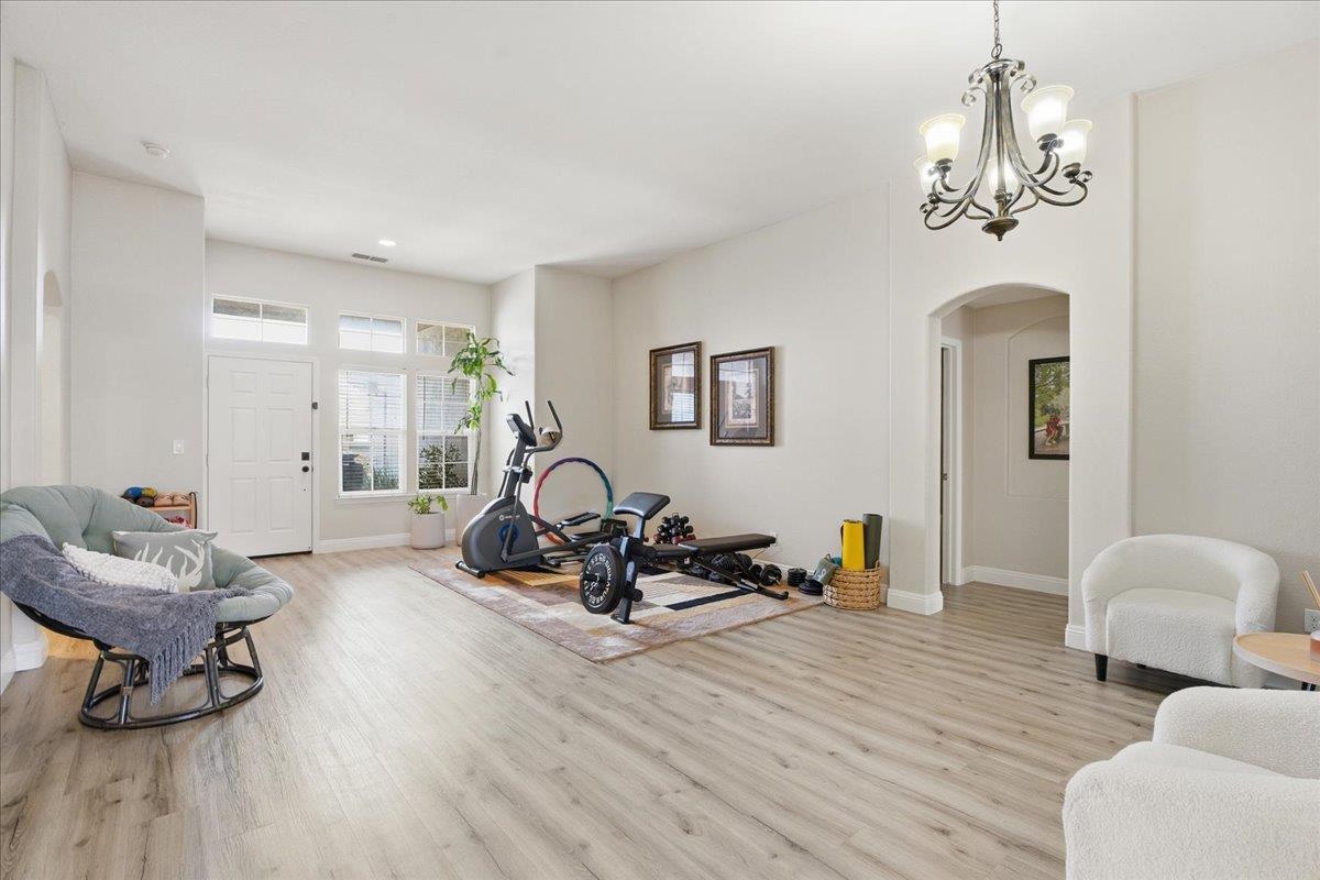 7821 Shell Beach Drive Antelope, CA 95843 - Photo 5 of 40 a living room with furniture a window and a chandelier