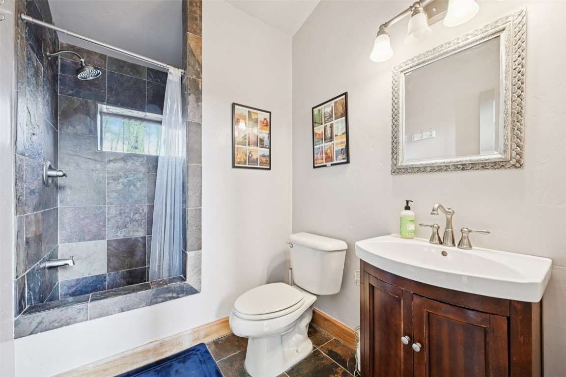 1499 Sheep Ridge Road Fairplay, CO 80440 - Photo 18 of 40 a bathroom with a sink toilet and shower