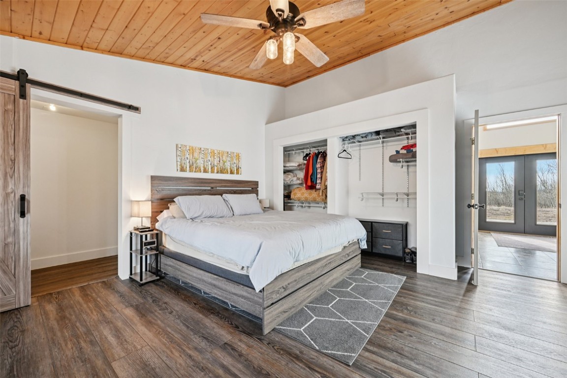 1499 Sheep Ridge Road Fairplay, CO 80440 - Photo 22 of 40 a spacious bedroom with a bed and a chandelier