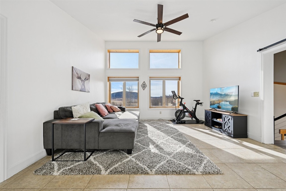 1499 Sheep Ridge Road Fairplay, CO 80440 - Photo 26 of 40 a living room with furniture a rug and a chandelier