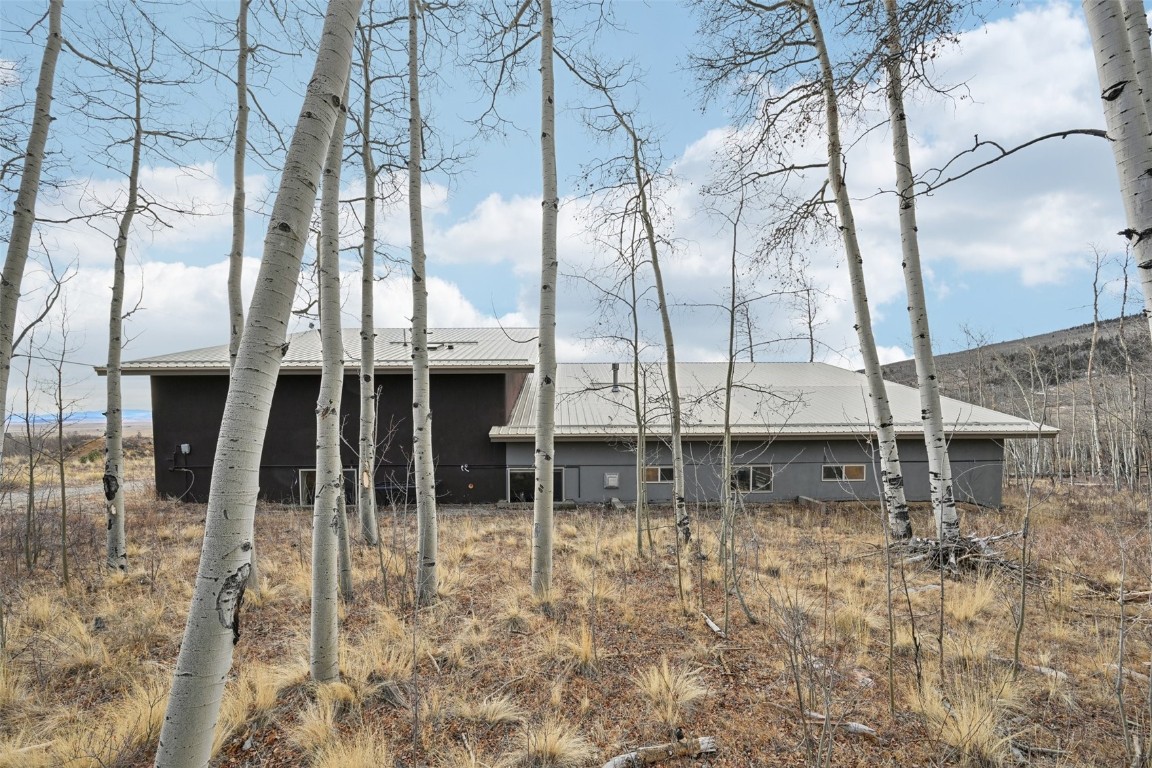 1499 Sheep Ridge Road Fairplay, CO 80440 - Photo 36 of 40 a backyard of a building with table and chairs