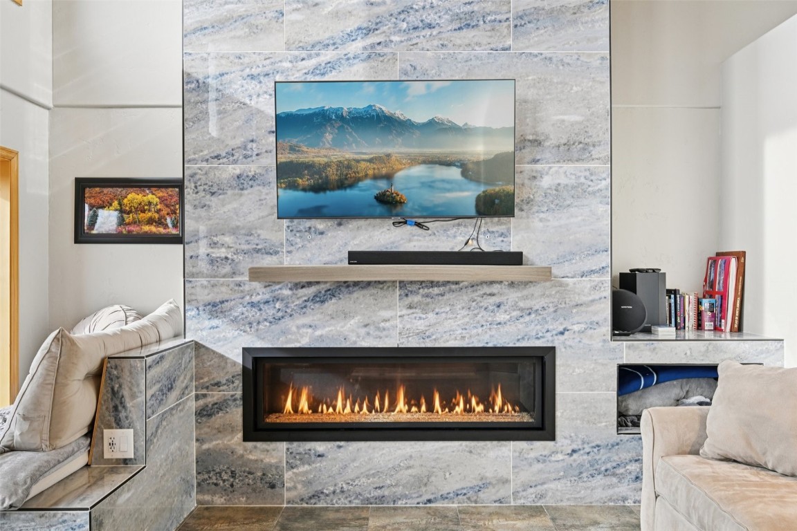 1499 Sheep Ridge Road Fairplay, CO 80440 - Photo 6 of 40 a fireplace with a clock on top of it