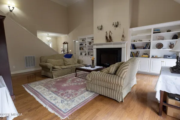 a living room with furniture and a fireplace