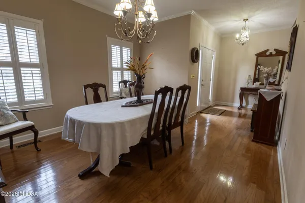 a view of a dining room with furniture and wooden floor