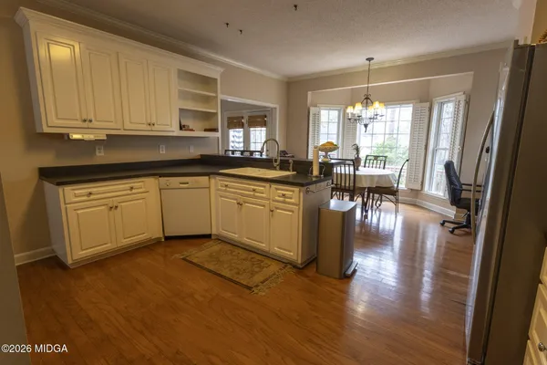 a kitchen with sink cabinets and wooden floor