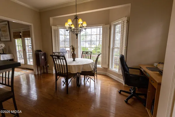 a view of a dining room with furniture window and wooden floor