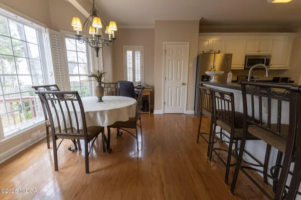 a view of a dining room with furniture window and wooden floor